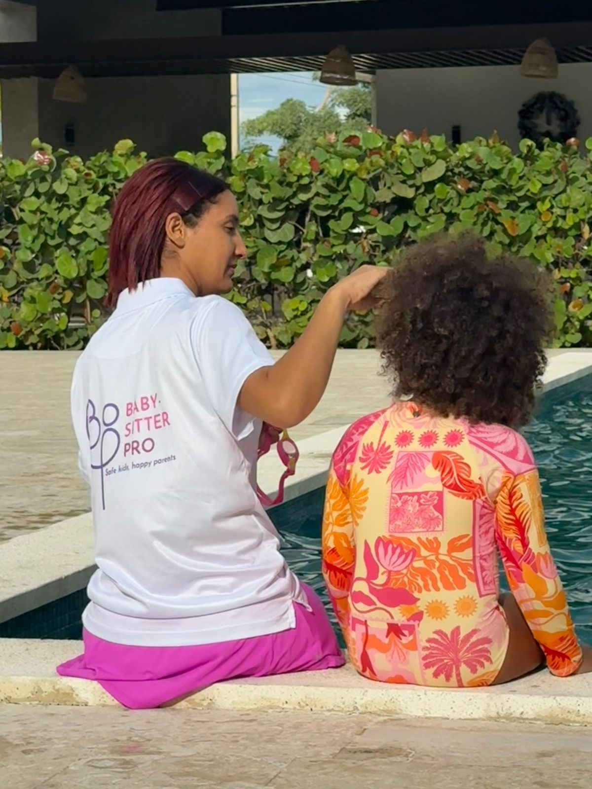 Babysitter PRO nanny caring for a child poolside